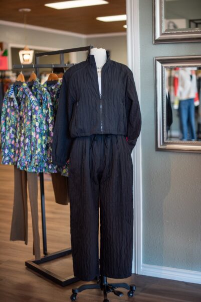 Black and printed outfits on clothing racks