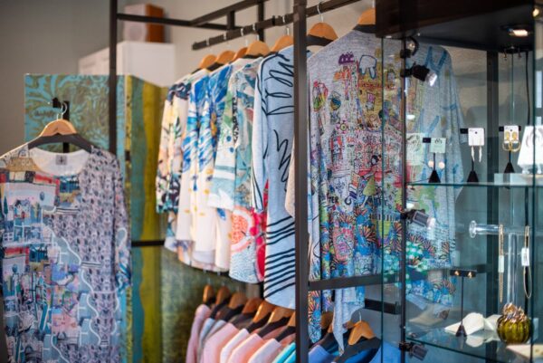 Blue print tops and pastel blouses on clothing racks