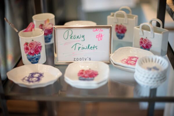 Peony print trinket dishes and cups on a glass display table